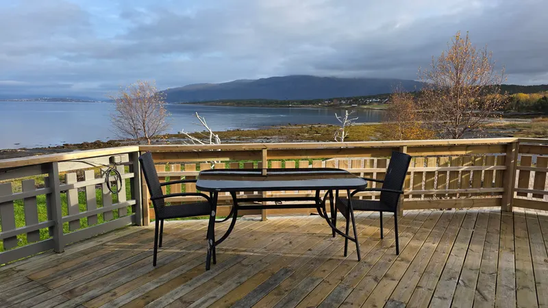 The shared terrace with tables and chairs, facing Tromsø